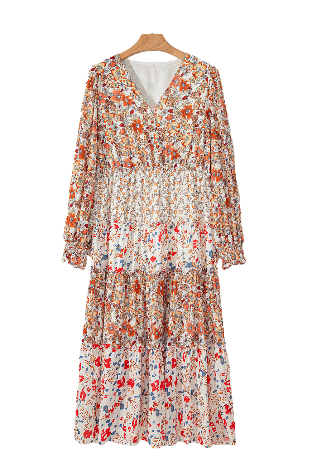 Floral dress on a hanger against a white background