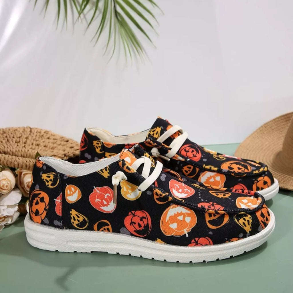 Sneakers with Halloween-themed design on a light green surface with a neutral background